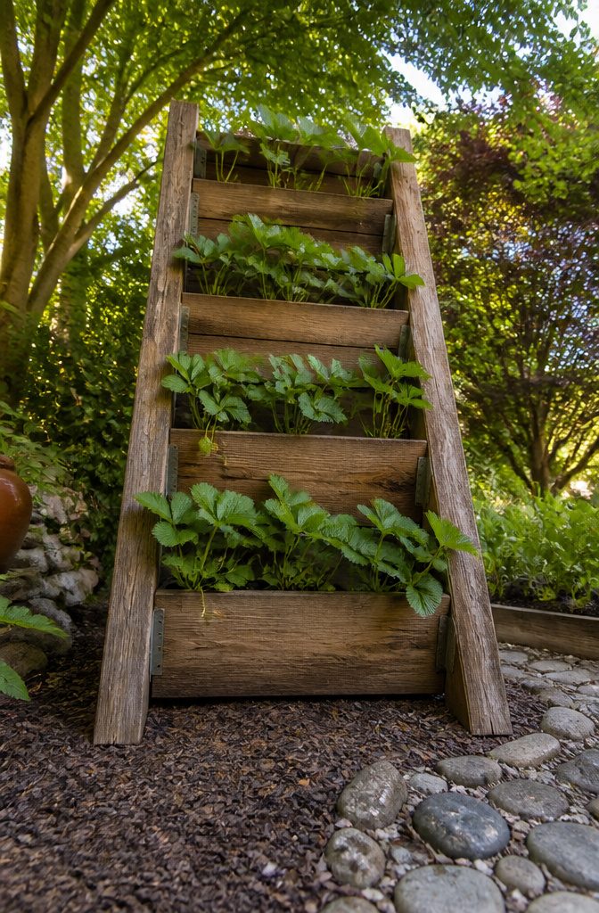 12 Inexpensive Raised Garden Bed Ideas for 2026 10 Stacked planter boxes creating a tiered vertical garden.